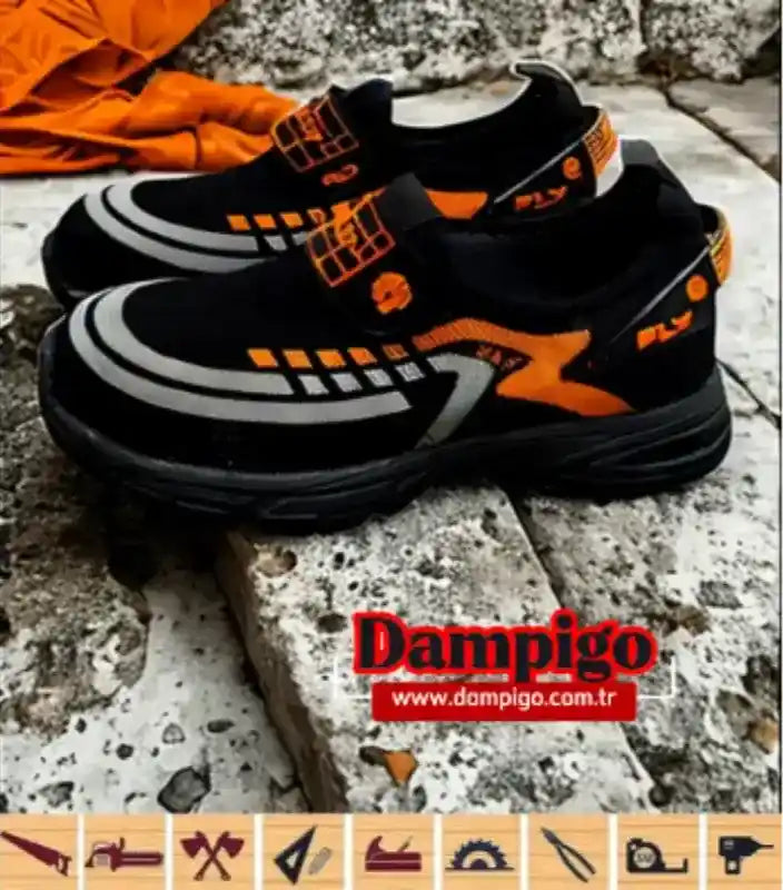 Dampigo FLY model iş güvenliği ayakkabısı, kaymaz taban ve çelik burun özellikli, siyah-turuncu renk kombinasyonu ile dış mekanda görüntüleniyor.